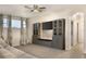 Second living space with custom cabinetry, wall-mounted TV and neutral color scheme at 1157 Hollow Pine Dr, Oviedo, FL 32765