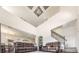 Spacious living room with a high ceiling, modern chandelier, and comfortable leather couches, creating an inviting atmosphere at 1157 Hollow Pine Dr, Oviedo, FL 32765