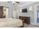 Main bedroom featuring an elegant dresser and wall-mounted TV at 1157 Hollow Pine Dr, Oviedo, FL 32765