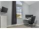 Bright office with a minimalist desk, dual monitors, and a modern chair, bathed in natural light at 1157 Hollow Pine Dr, Oviedo, FL 32765