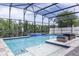 Gorgeous screened pool features a charming spa area and a table with cushioned seating at 1157 Hollow Pine Dr, Oviedo, FL 32765