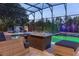 Inviting screened-in pool and outdoor seating area featuring a fire pit at 1157 Hollow Pine Dr, Oviedo, FL 32765