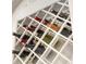 Close-up of the built-in wine rack showcasing various wine bottles in a decorative design at 1157 Hollow Pine Dr, Oviedo, FL 32765