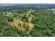 An aerial view of a sprawling lot surrounded by lush green trees at 20250 Nw 71St Ct, Micanopy, FL 32667