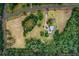 An attractive aerial view of property lines showcasing a property with a pond and wooded surroundings at 20250 Nw 71St Ct, Micanopy, FL 32667
