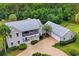 Overhead view showcasing the home and detached garage, surrounded by lush greenery at 20250 Nw 71St Ct, Micanopy, FL 32667