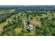 A beautiful aerial view of the home, driveway and lawn from an elevated point at 20250 Nw 71St Ct, Micanopy, FL 32667
