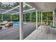 A backyard featuring a screened-in patio with a cozy pool and outdoor dining area at 20250 Nw 71St Ct, Micanopy, FL 32667