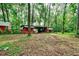 Exterior view of red wood barn with white accents at 20250 Nw 71St Ct, Micanopy, FL 32667
