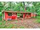 Exterior view of red wood barn with white accents at 20250 Nw 71St Ct, Micanopy, FL 32667