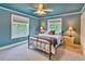 Comfortable bedroom featuring a ceiling fan, soft carpet and lots of light at 20250 Nw 71St Ct, Micanopy, FL 32667