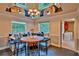 Cozy breakfast nook with banquette seating, a round wood table, comfortable cushions, and view to an adjacent laundry room at 20250 Nw 71St Ct, Micanopy, FL 32667