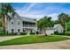 Charming home featuring a metal roof, spacious driveway, two-story porch, and mature landscaping at 20250 Nw 71St Ct, Micanopy, FL 32667
