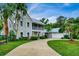 Charming home featuring a metal roof, spacious driveway, two-story porch, and mature landscaping at 20250 Nw 71St Ct, Micanopy, FL 32667