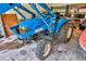Close up of blue Well Built GB-240 tractor parked in garage at 20250 Nw 71St Ct, Micanopy, FL 32667