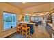 Well-lit kitchen with slate floors, blue cabinets, view to pool, an island with cooktop, and breakfast bar seating at 20250 Nw 71St Ct, Micanopy, FL 32667