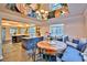 Bright kitchen featuring a breakfast nook with banquette seating, a mirrored ceiling, and slate floors, with sightlines to the kitchen at 20250 Nw 71St Ct, Micanopy, FL 32667