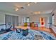 Large living room with wood floors, an area rug, and access to a laundry room, all brightened by natural light at 20250 Nw 71St Ct, Micanopy, FL 32667