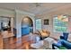 Open living room with hardwood floors, bar area, and plenty of natural light at 20250 Nw 71St Ct, Micanopy, FL 32667