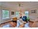 Comfortable living area with hardwood floors, bright windows, and stylish furnishings at 20250 Nw 71St Ct, Micanopy, FL 32667