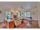 Spacious living room with a fireplace, hardwood floors, and comfortable seating area at 20250 Nw 71St Ct, Micanopy, FL 32667
