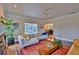 Bright living room with hardwood floors and a view of the screened in pool area at 20250 Nw 71St Ct, Micanopy, FL 32667