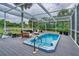 Backyard featuring a pool, surrounded by chairs and a grill at 20250 Nw 71St Ct, Micanopy, FL 32667