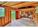 Interior view of wood shed with shelving and open door at 20250 Nw 71St Ct, Micanopy, FL 32667