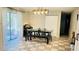 Dining room featuring modern table, bench, chairs, tile flooring, and sliding glass door at 251 Celery Cir, Oviedo, FL 32765