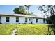 Well-maintained single-story home featuring a bright white exterior and green lawn at 251 Celery Cir, Oviedo, FL 32765
