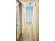 Hallway with wood-look flooring, white doors, neutral walls, and modern lighting at 251 Celery Cir, Oviedo, FL 32765