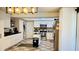 Bright kitchen featuring white cabinets, stainless appliances, tile flooring, and modern lighting at 251 Celery Cir, Oviedo, FL 32765