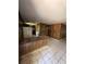 Open kitchen area with retro-style bar, tile flooring, wood paneling and appliances at 15750 Ne 150Th Ter, Fort Mc Coy, FL 32134