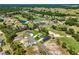 Aerial view of a gray home on a large lot near a golf course and other homes at 17781 Sw 72Nd Street Rd, Dunnellon, FL 34432