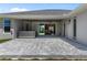 Covered back patio with stone pavers, hot tub, fan, and sliding doors to living area at 17781 Sw 72Nd Street Rd, Dunnellon, FL 34432
