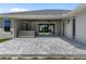 Back patio with pavers, covered area, hot tub, and access to the home's interior at 17781 Sw 72Nd Street Rd, Dunnellon, FL 34432