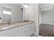 Bathroom with double vanity, granite countertops, and a walk-in shower at 17781 Sw 72Nd Street Rd, Dunnellon, FL 34432