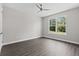 Bedroom with wood flooring, a ceiling fan, and a large window at 17781 Sw 72Nd Street Rd, Dunnellon, FL 34432