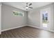 Bedroom with wood floors, ceiling fan, exterior door, and an outdoor view at 17781 Sw 72Nd Street Rd, Dunnellon, FL 34432