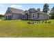 Gray home with stone accents, a two-car garage, and a well-manicured front lawn at 17781 Sw 72Nd Street Rd, Dunnellon, FL 34432