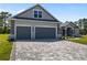 Charming single-Gathering home featuring a spacious paved driveway and attached two-car garage, stone clad columns, and well-manicured lawn at 17781 Sw 72Nd Street Rd, Dunnellon, FL 34432