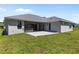 Back exterior showcasing the patio, hot tub and manicured backyard at 17781 Sw 72Nd Street Rd, Dunnellon, FL 34432