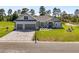 Charming gray home with a paver driveway, two-car garage, and landscaped front yard at 17781 Sw 72Nd Street Rd, Dunnellon, FL 34432