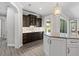 Elegant kitchen with dark wood cabinets, mosaic backsplash, and stainless steel appliances at 17781 Sw 72Nd Street Rd, Dunnellon, FL 34432
