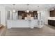 Modern kitchen featuring custom cabinets, quartz countertop island with pendant lighting, stainless appliances, and wood flooring at 17781 Sw 72Nd Street Rd, Dunnellon, FL 34432