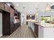 Spacious kitchen showcasing dark cabinetry, stainless appliances and a large island with a sink at 17781 Sw 72Nd Street Rd, Dunnellon, FL 34432