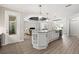 Open kitchen features a large center island with seating and seamless flow to the living area at 17781 Sw 72Nd Street Rd, Dunnellon, FL 34432