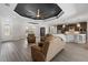 Bright, open living space with a decorative ceiling, neutral walls, wood floors and seamlessly integrates the kitchen at 17781 Sw 72Nd Street Rd, Dunnellon, FL 34432