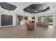 Spacious living room with open access to the kitchen, recessed lighting, neutral walls, and wood flooring throughout at 17781 Sw 72Nd Street Rd, Dunnellon, FL 34432
