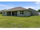 Home's backyard has a covered patio and generous lawn space at 17887 Sw 72Nd Street Rd, Dunnellon, FL 34432